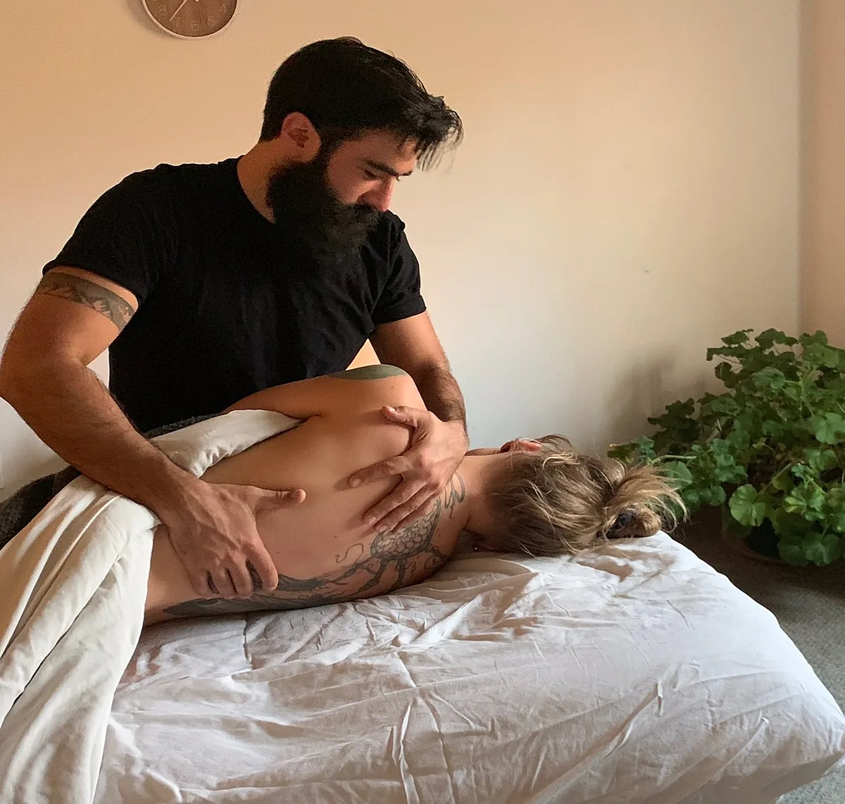 Izzy working along a client's side, his attention on his hands