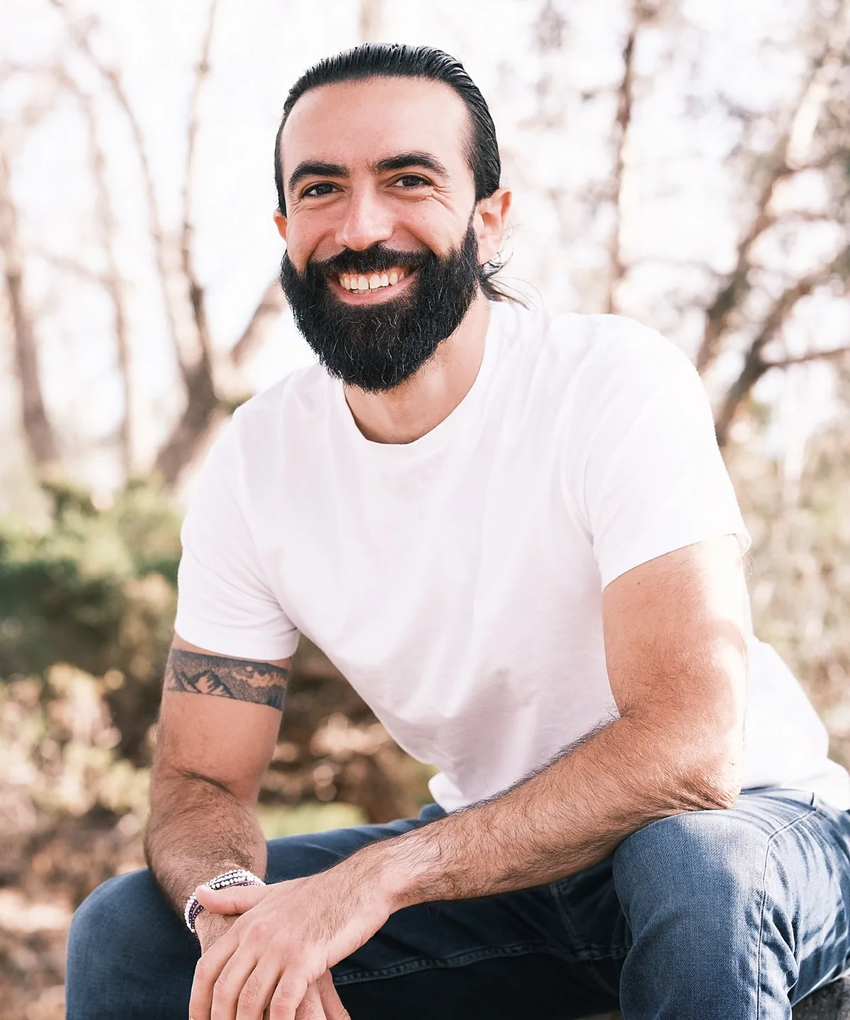 Izzy outdoors, seated, smiling