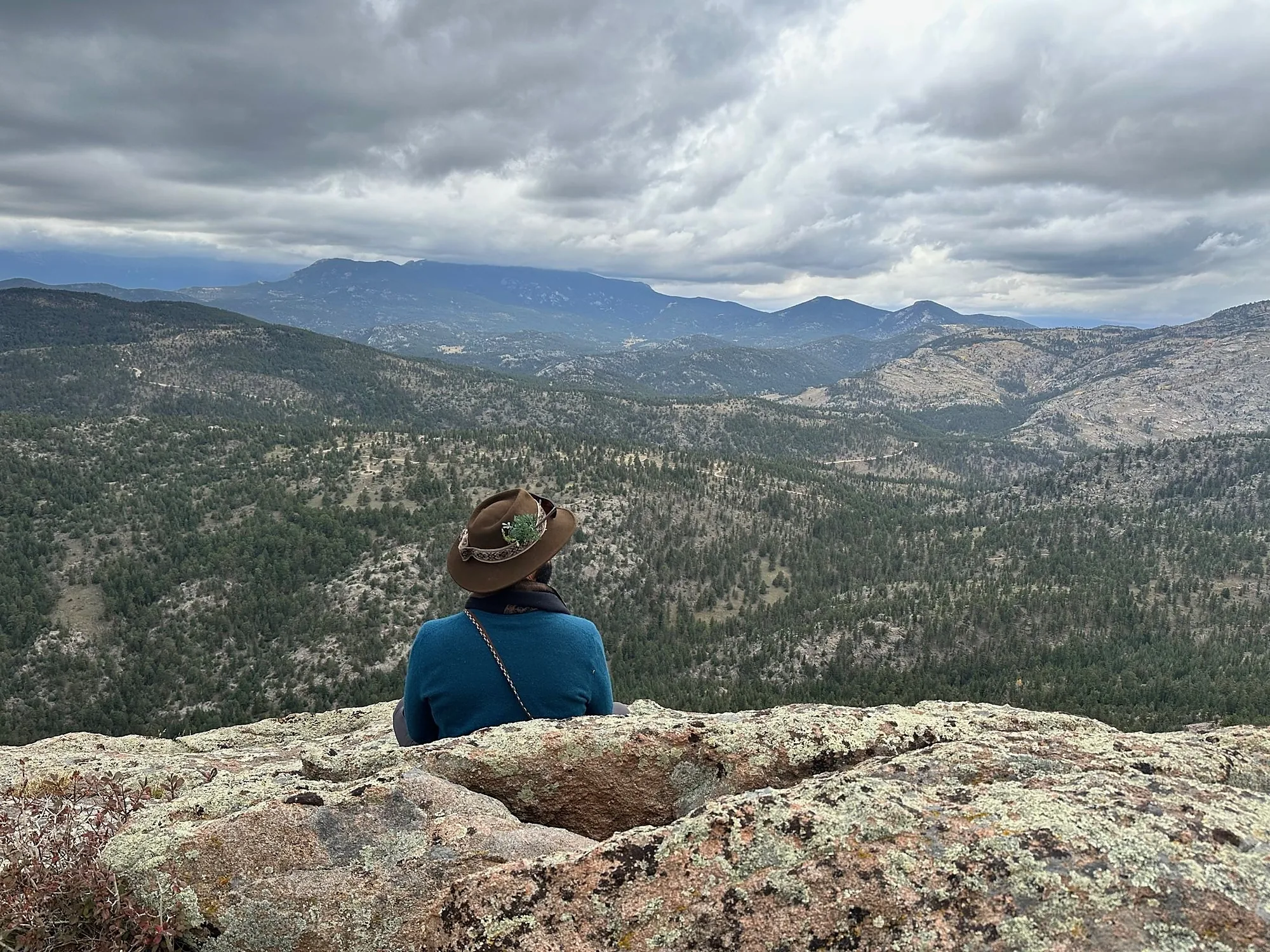 Sitting alone on a granite outcrop, looking out over the Colorado foothills